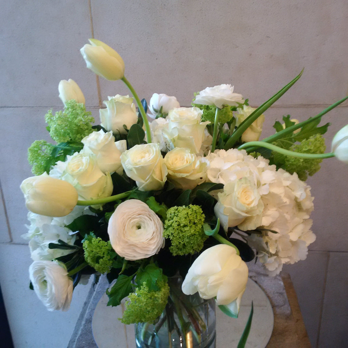 Custom floral arrangement created with a curated selection of fresh seasonal flowers and greenery.