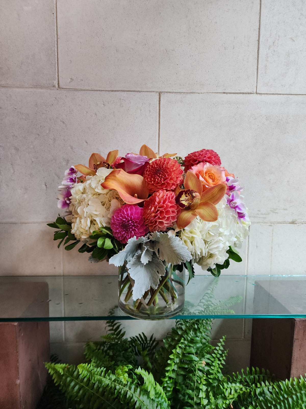 Big and Bold Vase Arrangement with colorful seasonal flowers in a clear glass vase.